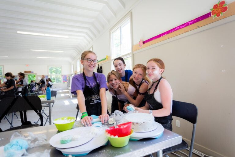 A group of girls baking a cake