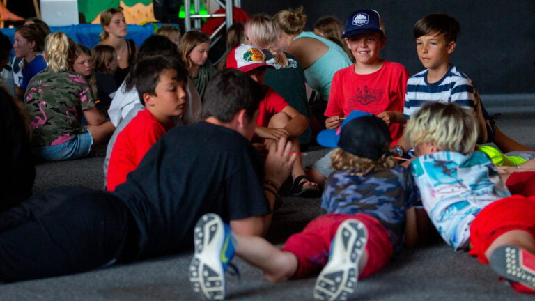 Muskoka Woods campers and staff lying on a floor chatting