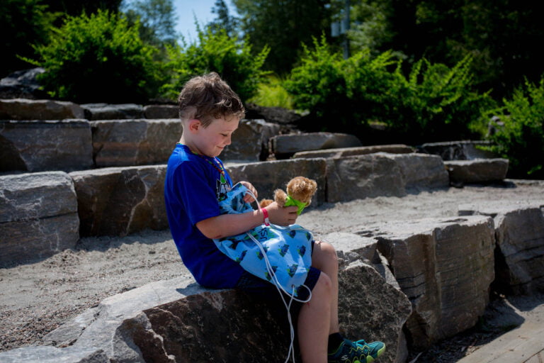 A young boy looks through a bag with toys