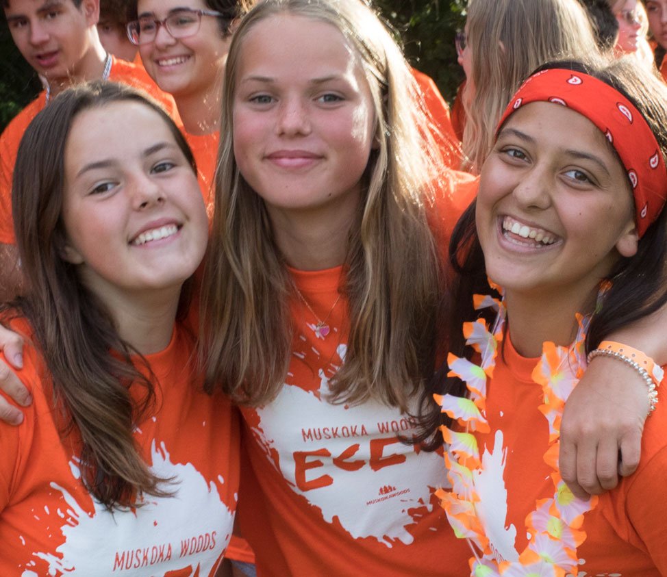 three girls in orange shirts