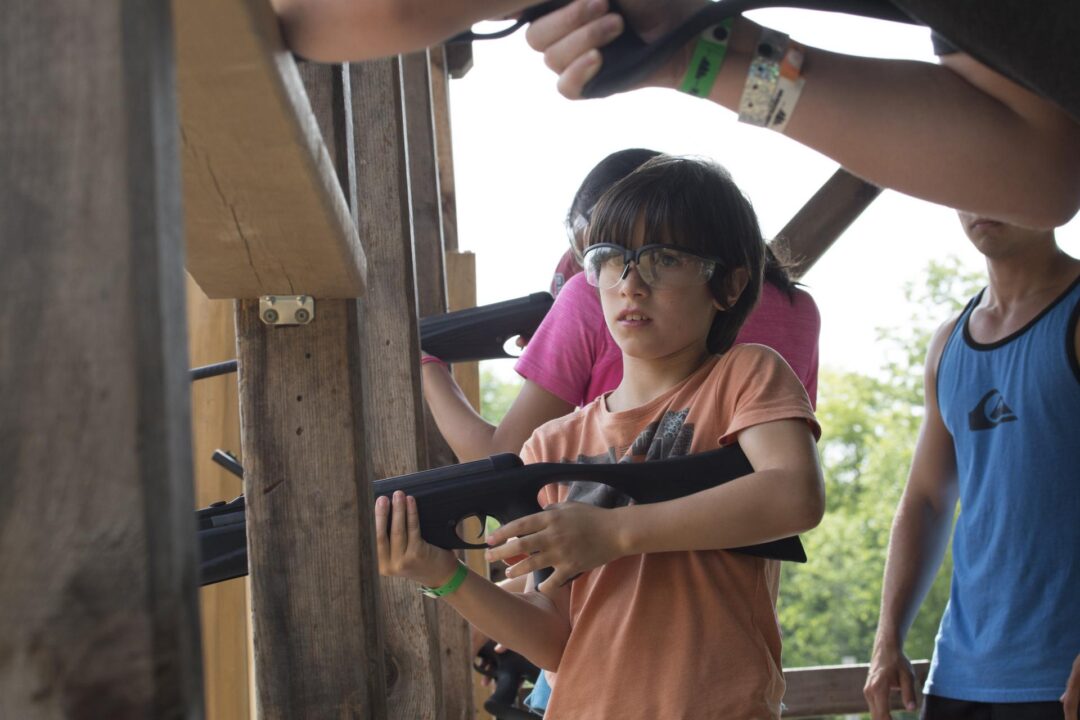 a boy learning about marksmanship